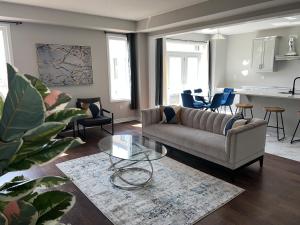 a living room with a couch and a table at 4 bedroom Pickering home in Pickering