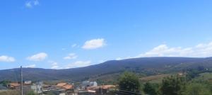 a view of a town with mountains in the background at Pousada Monte Belo in Carrancas