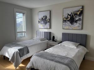 a bedroom with two beds and a window at Main Unit Luxury South Windsor Oasis in Windsor +34 photos