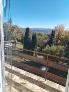 a view from a balcony with a fence and trees at Вила "до Гората" in Zărkwischte