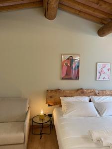 a bedroom with two beds and a couch and a table at Corte Bonfiglio Colombari in Illasi