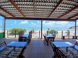 a view of the beach from a restaurant with tables and chairs at Bella Natal praia hotel in Natal