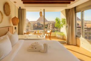 a hotel room with a bed with a swan on it at Galaxy Pyramids View INN in Cairo +76 photos