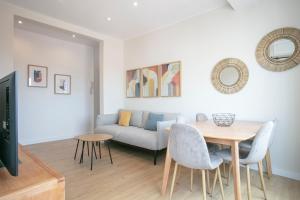 a living room with a table and a couch at Alcam Terrassa in Terrassa