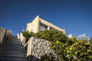 a building with stairs in front of a building at Viva B&B in Anavyssos