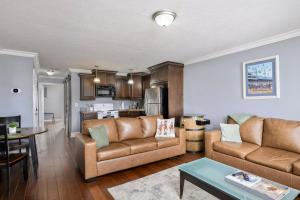 a living room with a couch and a table at American Pharaoh Twin Spires Suite in Jeffersonville