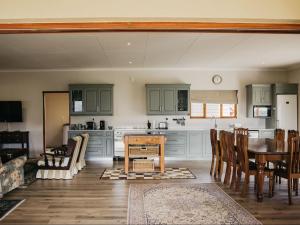 a kitchen with a table and a dining room at Ontevreden Farm in Montagu