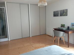 a bedroom with a desk and a chair at Le Cosy in Hiersac