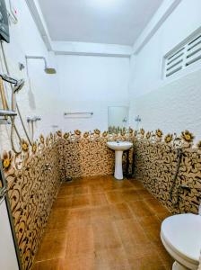 a bathroom with a sink and a toilet at purple villa in Mirissa