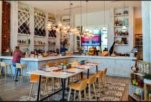 a restaurant with a bar with tables and chairs at Beautiful Beach front condo with Top Amenities in Hollywood