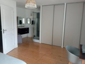 a living room with white cabinets and a wooden floor at Le Cosy in Hiersac