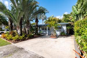 a house with palm trees and a driveway at The Residences at Lake Ridge Apt 1 in Fort Lauderdale +8 photos