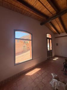 an empty room with a large window in a building at El Patio in Purmamarca