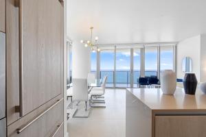 a kitchen and dining room with a view of the ocean at Dreamy Beachside Living - Direct Oceanview 2BR 2BA for the Perfect Escape in Hollywood +58 photos