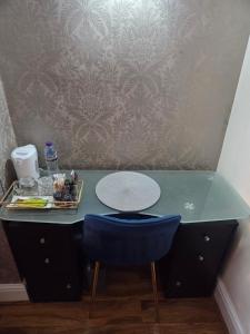 a desk with a blue chair and a plate on it at Liverpool Lux stay in Liverpool