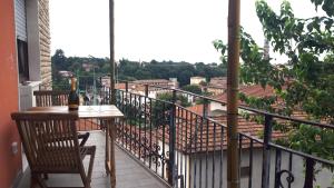 a table and chairs on a balcony with a bottle of wine at La nuova casa di Giove in Palazzolo sullʼOglio