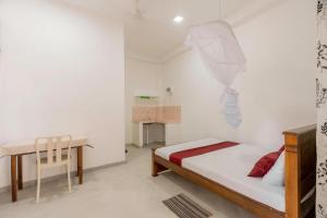 a small bedroom with a bed and a desk at Lakru Home Stay in Weligama +7 photos