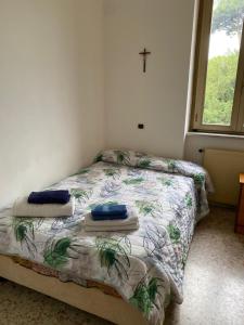 a bedroom with a bed with two pillows on it at Struttura Religiosa Via Francigena Velletri in Velletri
