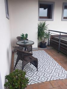 a patio with a table and chairs on a rug at Albergo ai Sapori in San Daniele del Friuli