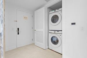 a laundry room with two washing machines in it at Dreamy Beachside Living - Direct Oceanview 2BR 2BA for the Perfect Escape in Hollywood