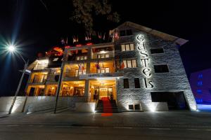 a building with a sign on it at night at Hotel Castel Suceava in Suceava