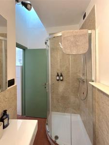a shower with a glass door in a bathroom at Casa Siena Piazzetta in Siena
