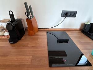 a laptop computer sitting on top of a wooden floor at SUN by Sun&Moon Cabins in Chicioreni