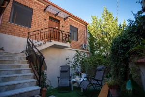 a house with a balcony and two chairs and a table at Casa Scano in Morgongiori