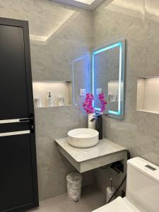 a bathroom with a sink and a mirror at Fovahi shark view inn in Fuvahmulah