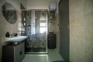 a bathroom with a sink and a shower at Casa Scano in Morgongiori +43 photos