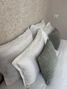a pile of pillows on a bed in a room at Verana House in Arguineguín