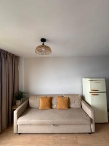 a living room with a couch and a refrigerator at Verana House in Arguineguín +3 photos