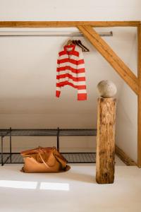 a red and white striped sweater hanging on a wall at Wabi Sabi Loft im Wienerwald in Laaben