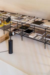 a room with several racks of books on a wall at Wabi Sabi Loft im Wienerwald in Laaben +6 photos