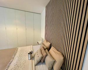 a bedroom with a bed with pillows on it at PULLY LAUSANNE sunny apartment on lakeside street and direct bus to Lausanne train station in Pully