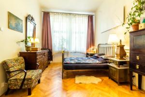 a bedroom with a bed and a chair at Family place in Old town/center in Liberec