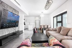 a living room with couches and a flat screen tv at O&O Group-Charming 4BR APT with Stellar Sea View in Bat Yam