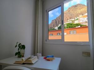 a room with a window and a book on a table at Fleitas Penthouse with terrace in San Andrés