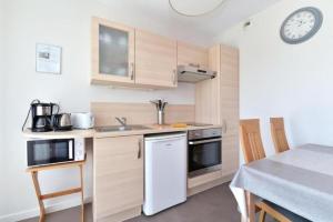 a small kitchen with a sink and a stove at Maison d'Hôtes Sainte Hune Chambres et appartements in Hunawihr