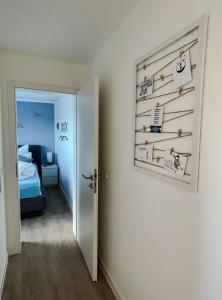a room with a wall with a picture of a bedroom at Seemöwe in Friedrichsschleuse +3 photos