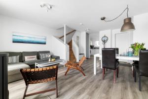 a living room with a couch and a table at Ferienhaus Seestern Olpenitz in Olpenitzdorf