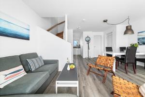 a living room with a couch and a table at Ferienhaus Seestern Olpenitz in Olpenitzdorf
