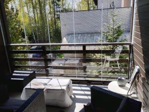 a balcony with a swing and a table and chairs at Villa Professor in Tallinn