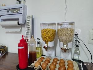 a counter with two food blenders and eggs on a table at Royal Inn - Fully Furnished Self-Catering Apartments in Lenasia +26 photos