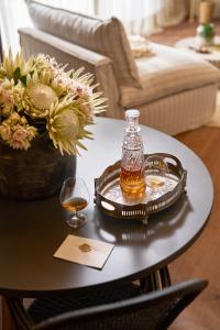 a bottle of whiskey on a tray on a table at The Alexander Estate in Good Hope