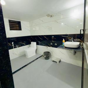 a white bathroom with a sink and a mirror at Holiday Homestay dholavira  +19 photos