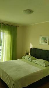 a bedroom with a large bed and a window at More in Vodice