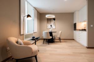 a living room with a chair and a table at Stella Braga Aparthotel in Braga