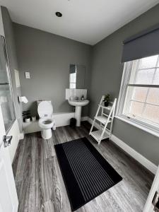 a bathroom with a toilet and a sink at Penthouse Parade Apartment, Sleeps 6 in Harrogate +21 photos