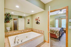a bathroom with a tub and a bedroom with a bed at Chetola: Berkshires 3 in Blowing Rock +54 photos